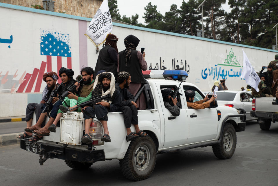 Taliban members ride in a pickup truck during a celebration of the first anniversary of the Taliban's return to power, August 15, 2022, in Kabul, Afghanistan. / Credit: Nava Jamshidi/Getty