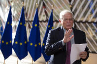 European Union foreign policy chief Josep Borrell reads a statement as he arrives for a meeting of EU foreign ministers at the European Council building in Brussels, Monday, July 13, 2020. European Union foreign ministers meet for the first time face-to-face since the pandemic lockdown and will assess their fraught relations with China and discuss the troubled relation with Turkey. (AP Photo/Virginia Mayo, Pool)/