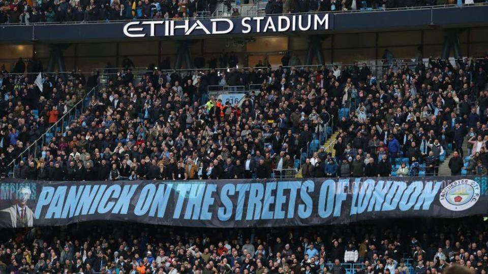 Man City fans celebrate their barrister Lord Pannick with a banner referencing lyrics from Manchester band The Smiths