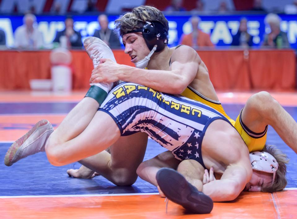 Galesburg's Gauge Shipp, top, tangles with Yorkville Christian's Ty Edwards in the 132-pound match of the Class 2A state wrestling championships Saturday, Feb. 17, 2024 at the State Farm Center in Champaign.