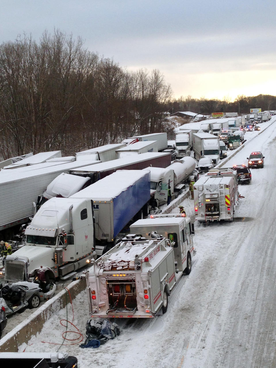 UPDATES NUMBER OF VEHICLES INVOLVED - In this photo provided by the Indiana State Police, emergency crews work at the scene of a massive pileup involving more than 40 vehicles, many of them semitrailers, along Interstate 94 Thursday afternoon, Jan. 23, 2014 near Michigan City, Ind. At least three were killed and more than 20 people were injured. (AP Photo/Indiana State Police)