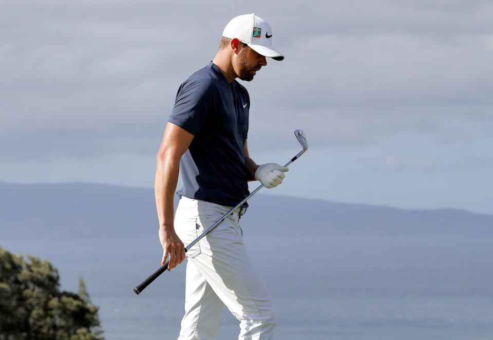 Kevin Tway looks at his club after hitting from the 11th tee during the second round of the Tournament of Champions golf event Friday, Jan. 4, 2019, at Kapalua Plantation Course in Kapalua, Hawaii. (AP Photo/Matt York)