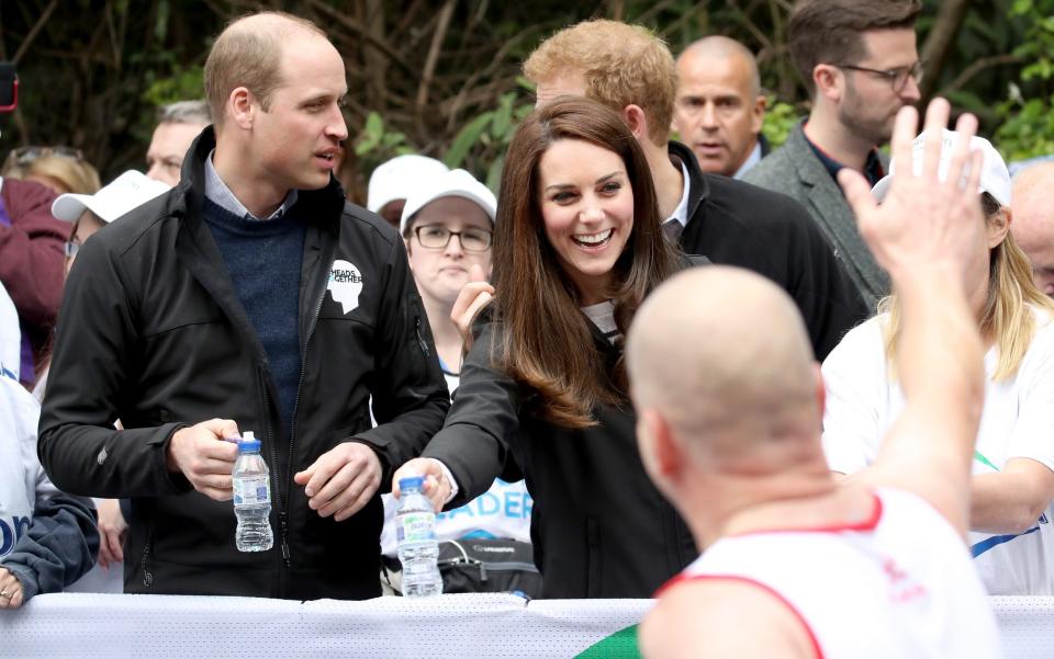 The Duke & Duchess Of Cambridge And Prince Harry wave on a runner - Credit: Chris Jackson - WPA Pool/Getty Images