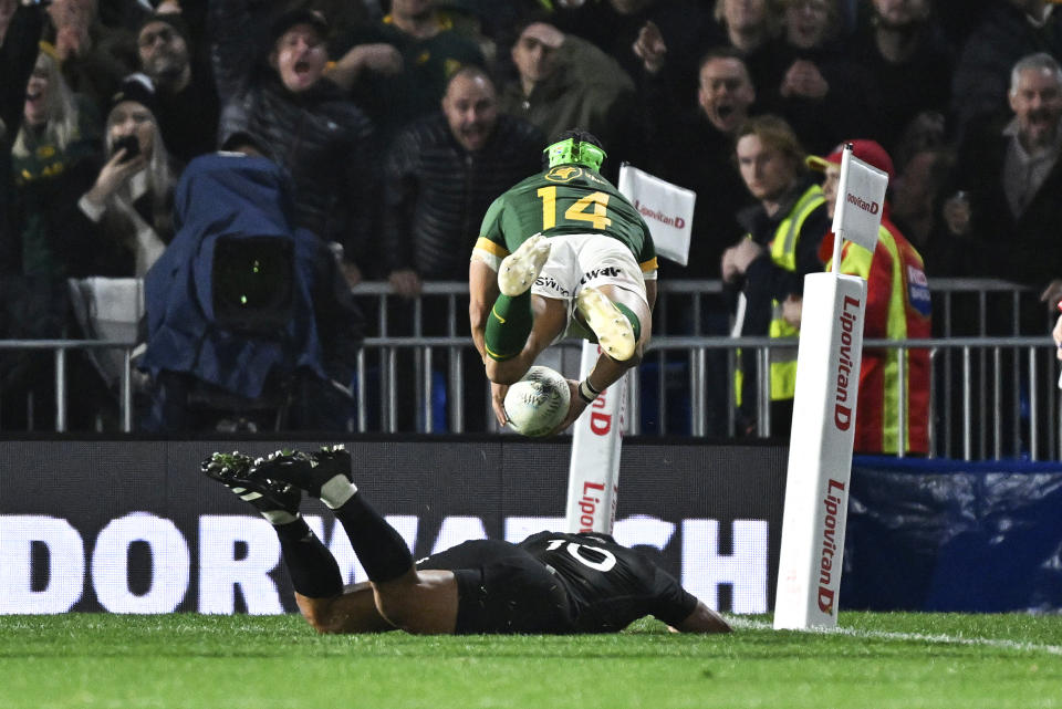 South Africa's Cheslin Kolbe is airborne as he scores a try during the Rugby Championship test match between the All Blacks and South Africa at Mt Smart Stadium in Auckland, New Zealand, Saturday, July 15, 2023. ( Alan Lee/Photosport via AP)