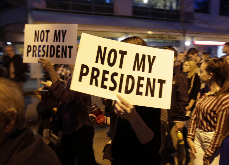 A woman holds a sign reading "not my president" during protest in Mostar, Bosnia, Thursday, Oct. 11, 2018. Several thousand Bosnian Croat nationalists have protested the election victory of a moderate politician last weekend in the race for the Croat seat in Bosnia's three-person presidency. The crowd Thursday marched through the ethnically divided southern town of Mostar holding banners reading "Not my president" and "RIP democracy" in protest at the election of Zeljko Komsic." (AP Photo/Amel Emric)