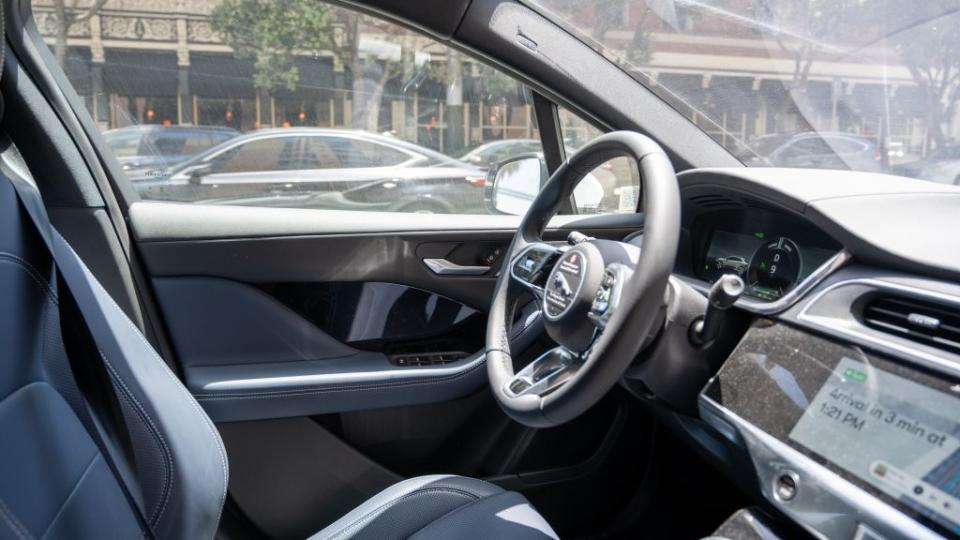 The interior of a Waymo self-driving car that is navigating through traffic.