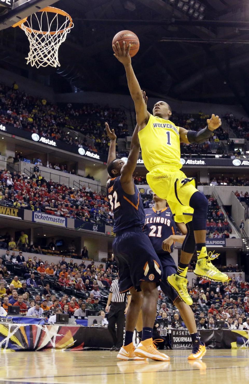Michigan forward Glenn Robinson III (1) goes up for a basket against Illinois center Nnanna Egwu (32) in the first half of an NCAA college basketball game in the quarterfinals of the Big Ten Conference tournament Friday, March 14, 2014, in Indianapolis. (AP Photo/Michael Conroy)