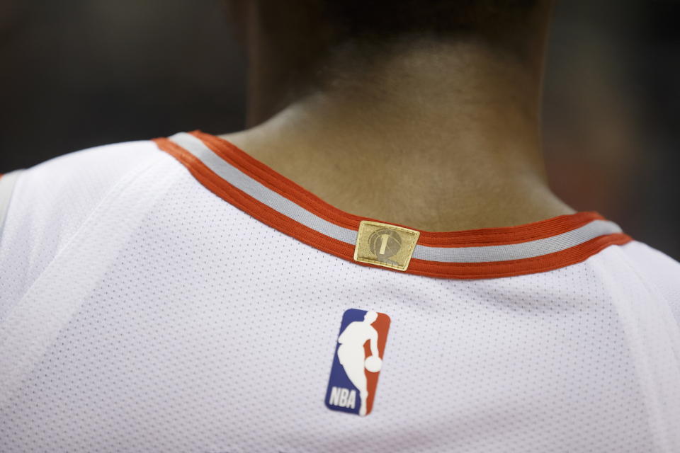 A championship tab is sewn to the back of the jersey of Toronto Raptors guard Cameron Payne during the second half of a preseason NBA basketball game against the Chicago Bulls in Toronto, Sunday, Oct. 13, 2019. (Cole Burston/The Canadian Press via AP)