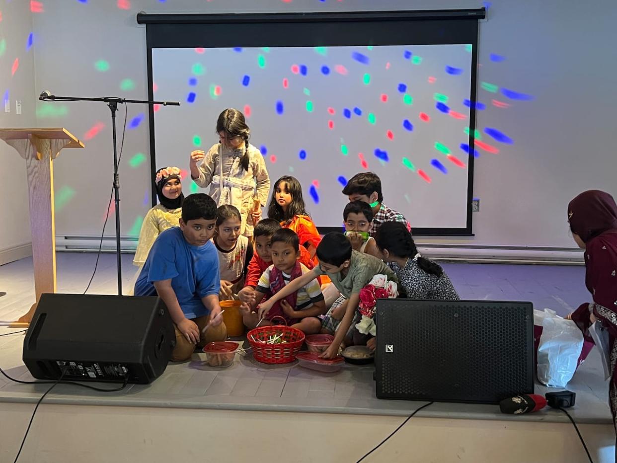 Kids of Bangladesh Community Association of Nova Scotia perform a piece conveying the different life experiences of children in Bangladesh. (Vernon Ramesar/CBC - image credit)