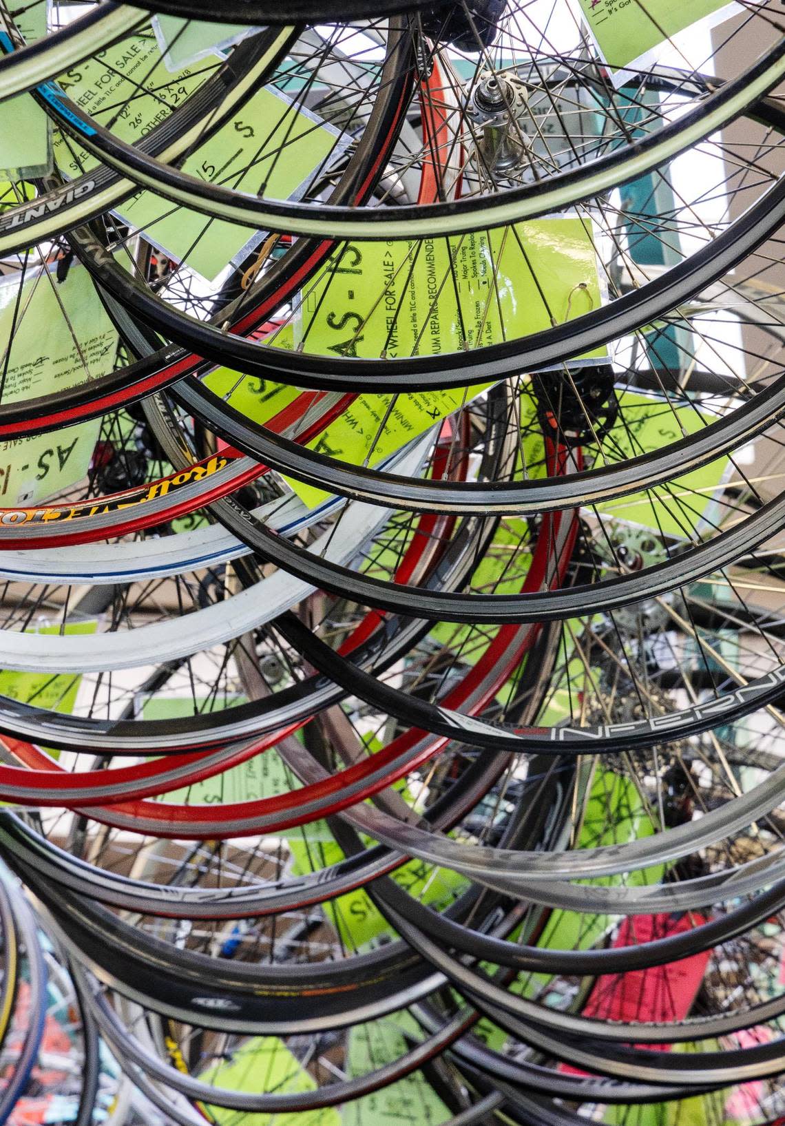 Bicycle wheels hang from the ceiling at the Boise Bicycle Project, where locals can purchase refurbished bikes or donate their own.