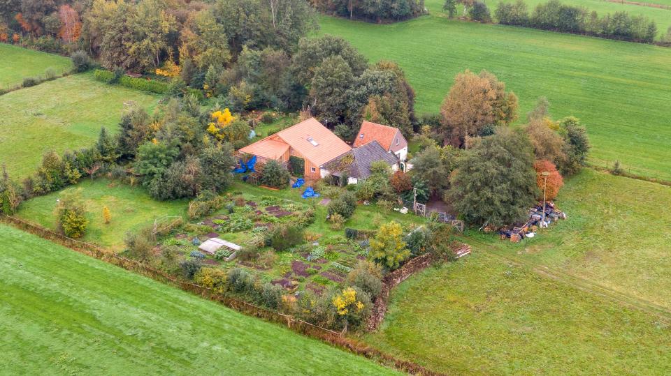 This aerial picture taken on October 15, 2019 shows a farmhouse in a remote area of northern Netherlands' province of Drenthe, near the village of Ruinerwold, where Dutch police discovered a hidden staircase behind a cupboard leading to a cellar where a man and five others believed to be his children aged between 18 and 25 were hidden and reportedly spent years "waiting for the end of time", officials said. - Local media said the family were found after one of the sons went to a nearby pub in a confused state, drank five beers and then asked for help, saying he had not been outside for nine years. Police arrested a 58-year-old man at the scene for failing to cooperate with the investigation, but he was not the father. Many questions were unanswered  and police are investigating "All scenarios". "At this point we cannot give further information," local police said. (Photo by Wilbert Bijzitter / ANP / AFP) / Netherlands OUT (Photo by WILBERT BIJZITTER/ANP/AFP via Getty Images)