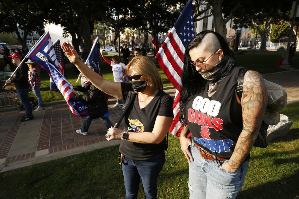 Rosie Ornelas, left with her daughter-in-law, Carley Ornelas, , pray as Pro-Trump demonstrators rallied outside city hall.