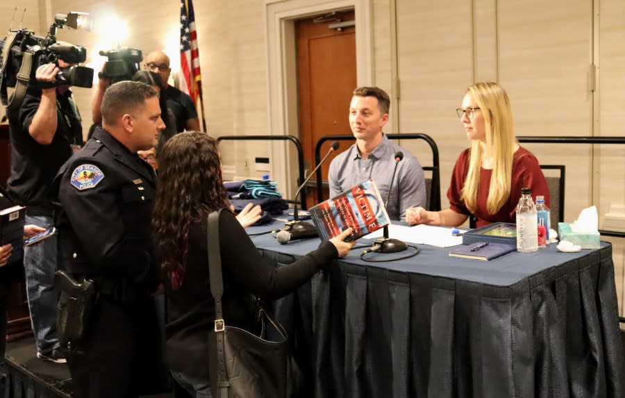 Aaron Quinn, left, and Denise Huskins, right, talk to a Seaside police officer at a law enforcement training event held on March 21, 2024 in Seaside. (KRON4 / Amy Larson)