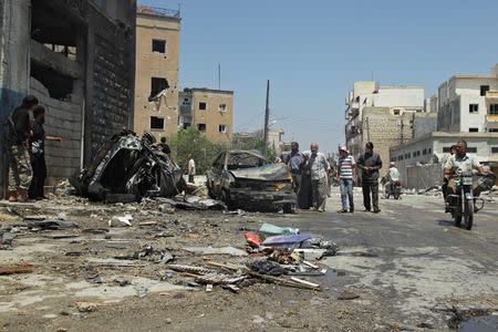 Civilians inspect a site hit by an airstrike in the rebel-controlled city of Idlib, Syria June 29, 2016. REUTERS/Ammar Abdullah