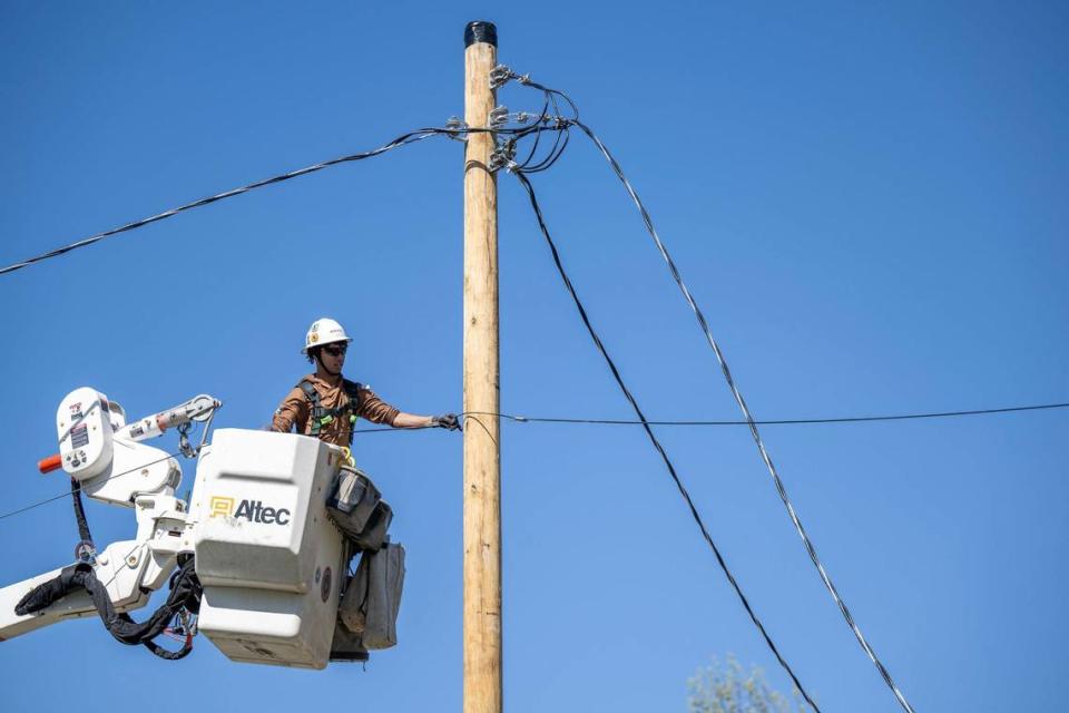 A lineman for Evergy worked to restore power to an area along 9100 Haskins St., in Lenexa after a large tree fell and brought down the power lines during severe storms that moved through the area on Tuesday, April 16, 2024.
