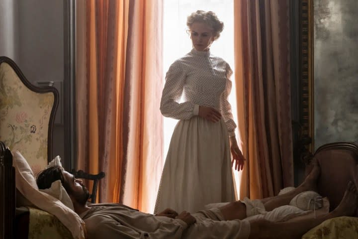 A woman looms over a bedridden man in The Beguiled.