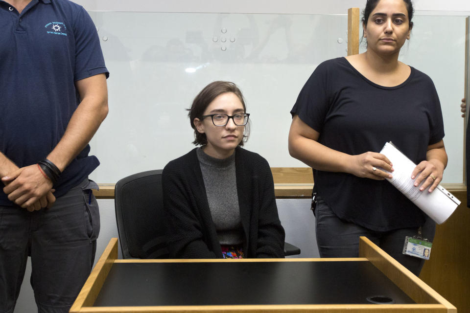 File - In this Thursday, Oct. 11, 2018 file photo, American Lara Alqasem, center, sits in a courtroom prior to a hearing at the district court in Tel Aviv, Israel. Alqasem asked Israel's Supreme Court to overturn an expulsion order over her alleged involvement in the boycott movement against Israel. Lara Alqasem has been held in detention since arriving in the country on Oct. 2 with a valid student visa. (AP Photo/Sebastian. Scheiner, File)