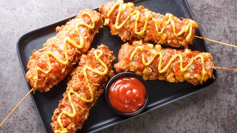 Corn dogs with condiments