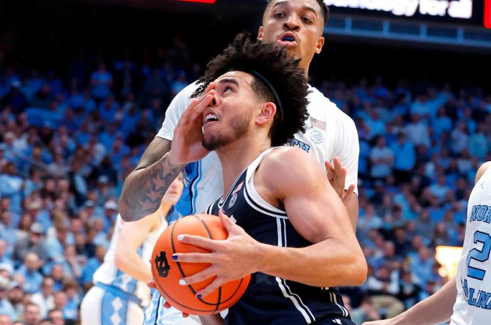 Duke’s Jared McCain (0) drives by North Carolina’s Armando Bacot (5) during the second half of UNC’s 93-84 victory over Duke at the Smith Center in Chapel Hill, N.C., Saturday, Feb. 3, 2024.