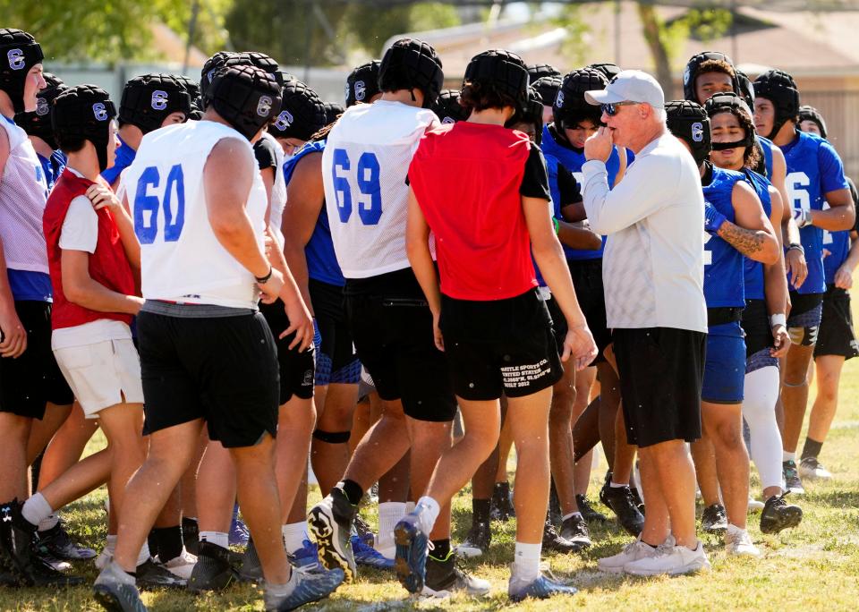 Chandler High football head coach Rick Garretson huddles with his team during spring football practice in Chandler on May 8, 2023.