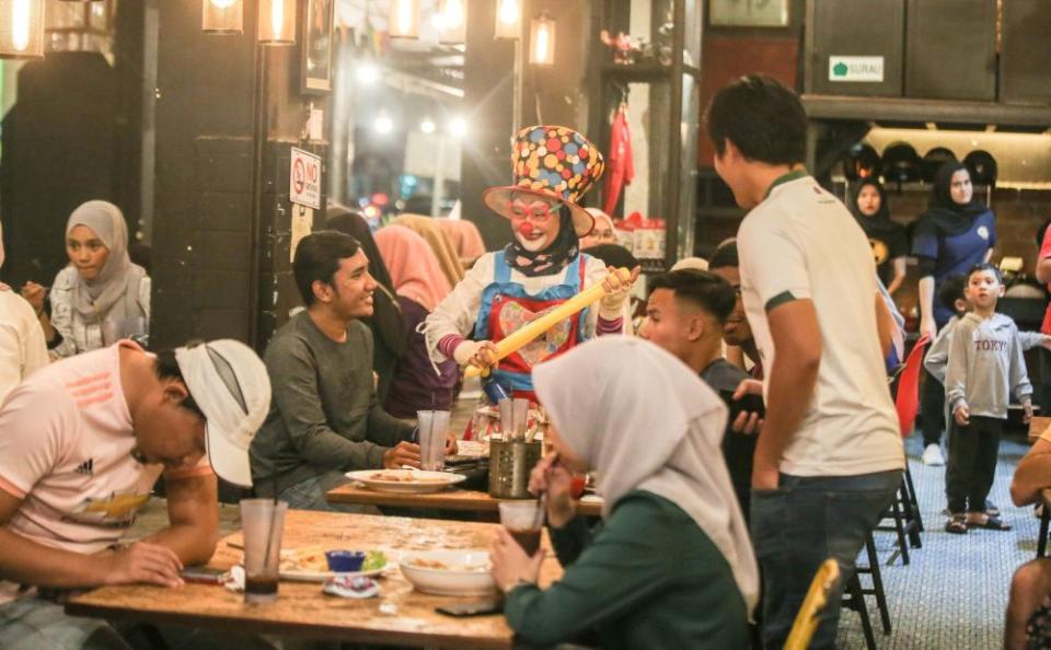 Nazirah works as a beauty consultant at a shopping complex in Ipoh by day and moonlights as a clown at the Konda Kondi cafe in Ipoh. — Picture by Farhan Najib