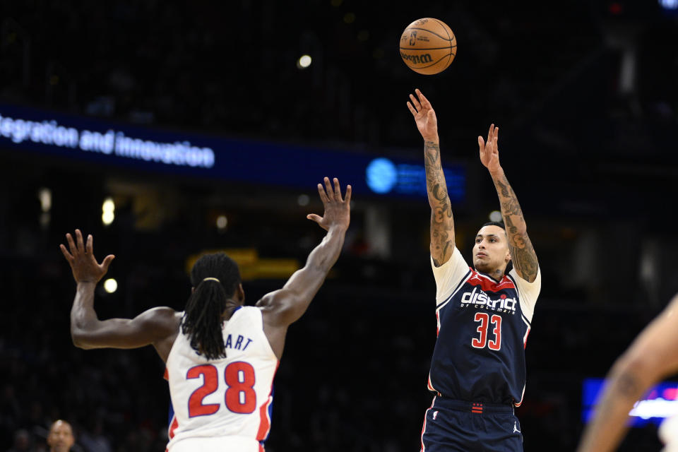 Washington Wizards forward Kyle Kuzma (33) shoots against Detroit Pistons center Isaiah Stewart (28) during the second half of an NBA basketball game, Monday, Jan. 15, 2024, in Washington. (AP Photo/Nick Wass)