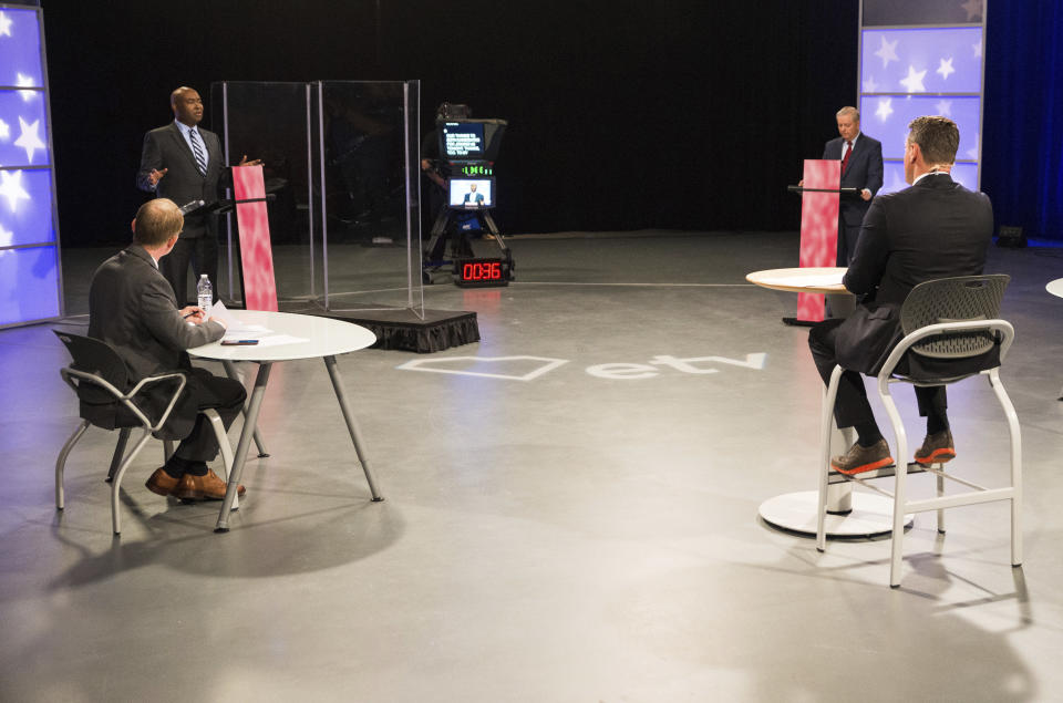 Democratic challenger Jaime Harrison, back left, and Sen. Lindsey Graham, R-S.C., participate in a debate in Columbia, S.C., Friday, Oct. 30, 2020. (John A. Carlos II/The Post And Courier via AP)