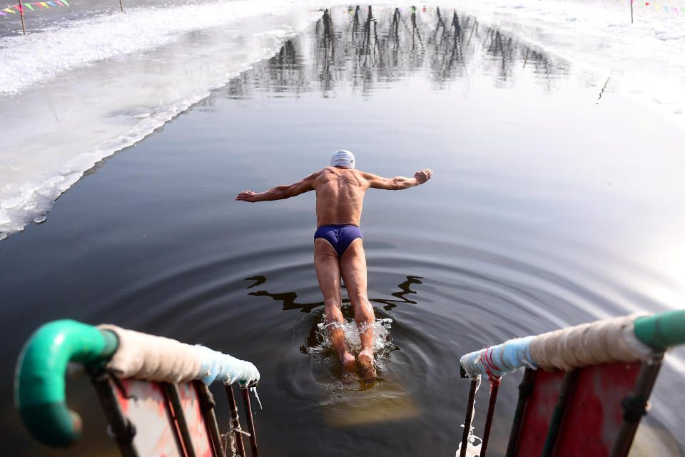 Winter swimmer dives into icy waters at a park in Shenyang
