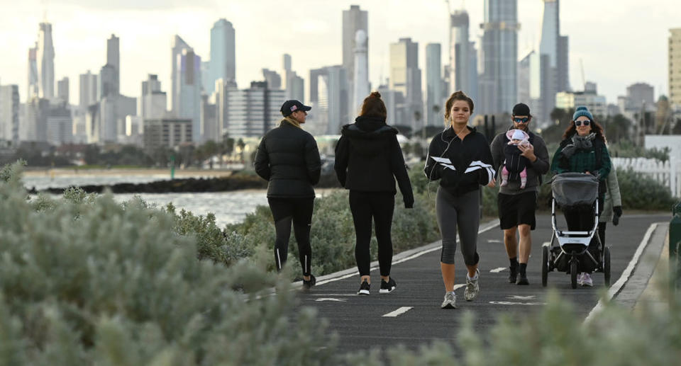 People walk on a path in Melbourne.