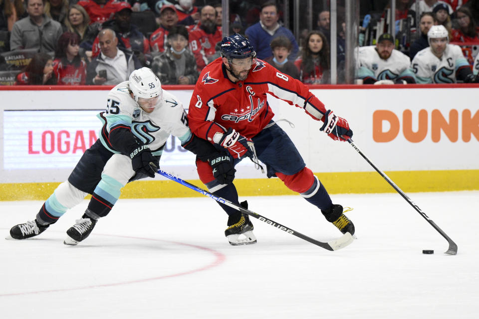 Washington Capitals left wing Alex Ovechkin (8) skates with the puck against Seattle Kraken defenseman Jeremy Lauzon (55) during the first period of an NHL hockey game, Saturday, March 5, 2022, in Washington. (AP Photo/Nick Wass)