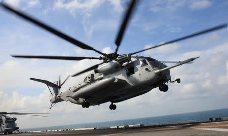 A CH-53E Super Stallion from Marine Medium Helicopter Squadron 268 departs the USS Makin Island amphibious assault ship on December 14, 2011 to fly Marine personnel to Kuantan, Malaysia for Exercise Kilat Eagle, a bilateral training event with the Malaysian military. REUTERS/U.S. Marine Corps/Capt. Roger Hollenbeck/Handout