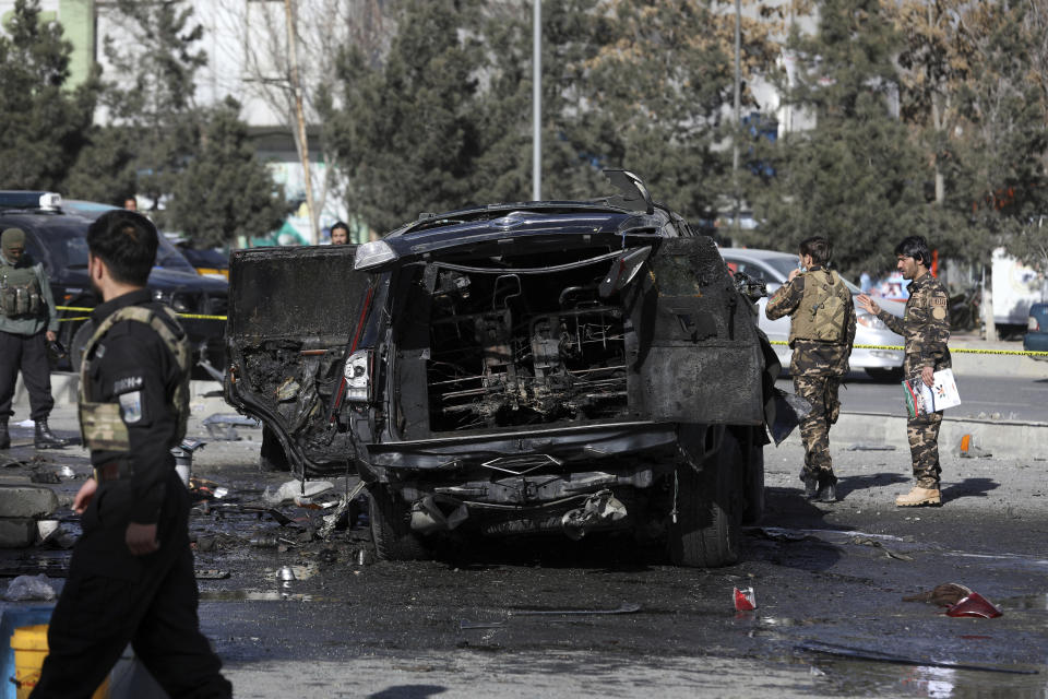 Afghan security personnel inspect the site of a deadly bomb attack in Kabul, Afghanistan, Wednesday, Feb. 10, 2021. (AP Photo/Rahmat Gul)