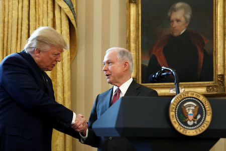 FILE PHOTO: Under a portrait of former President Andrew Jackson, U.S. President Donald Trump (L) congratulates Jeff Sessions after he was sworn in as U.S. Attorney General during a ceremony in the Oval Office of the White House in Washington, U.S., February 9, 2017. REUTERS/Kevin Lamarque/File Photo