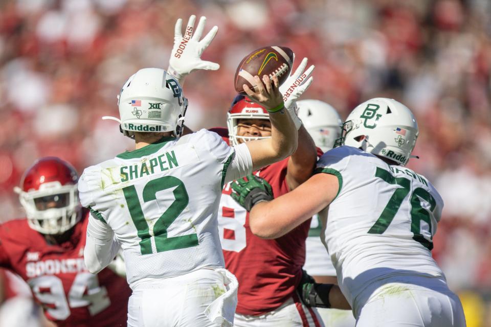 Baylor’s Blake Shapen (12) throws the ball under pressure in the first quarter of a 38-35 win at OU on Saturday.