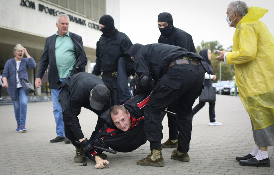 Police detain a man during an opposition rally to protest the official presidential election results in Minsk, Belarus, Sunday, Sept. 27, 2020. Hundreds of thousands of Belarusians have been protesting daily since the Aug. 9 presidential election. (AP Photo/TUT.by)