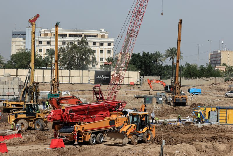 FILE PHOTO: Construction workers build the Rixos Baghdad, in Baghdad's Green Zone