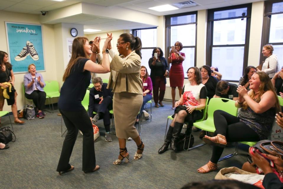 Weight Watchers member, investor and advisor Oprah Winfrey and her Weight Watchers coach celebrate with members at a Weight Watchers meeting on Tuesday, April 19, 2016 in New York City. Ms. Winfrey also shared the visit via <a href="https://fortune.com/company/facebook/" rel="nofollow noopener" target="_blank" data-ylk="slk:Facebook;elm:context_link;itc:0" class="link ">Facebook</a> Live. (Mark VonHolden/Invision for Weight Watchers)