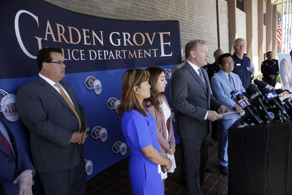 Garden Grove Mayor Steven R. Jones, fourth from left, speaks during a news conference following the arrest of Zachary Castaneda outside of the Garden Grove Police Department headquarters in Garden Grove, Calif., Thursday, Aug. 8, 2019. Investigators believe Castaneda, a documented gang member, stabbed several people to death and wounded a few others as he targeted his victims at random during a bloody rampage across two Southern California cities, authorities said. (AP Photo/Marcio Jose Sanchez)