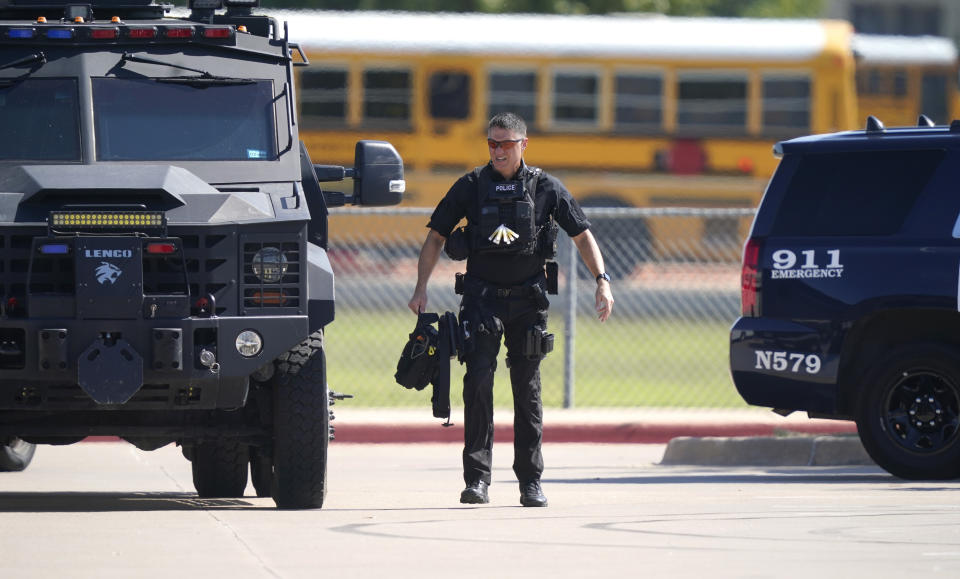 A law enforcement officer walks in the parking lot of Timberview High School after a shooting inside on Wednesday. Source: AP