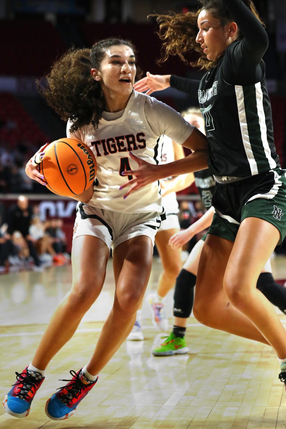 Norman's Keeley Parks drives around Norman North's Seleh Harmon in the Class 6A girls basketball state title game on March 9.