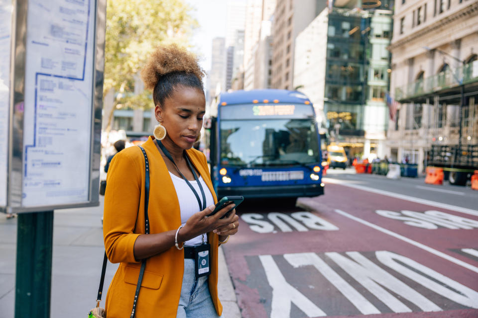 a woman waiting for the bus stop