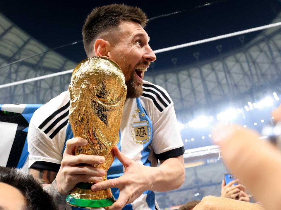 Lionel Messi of Argentina celebrates with the FIFA World Cup Qatar 2022 Winner's Trophy.