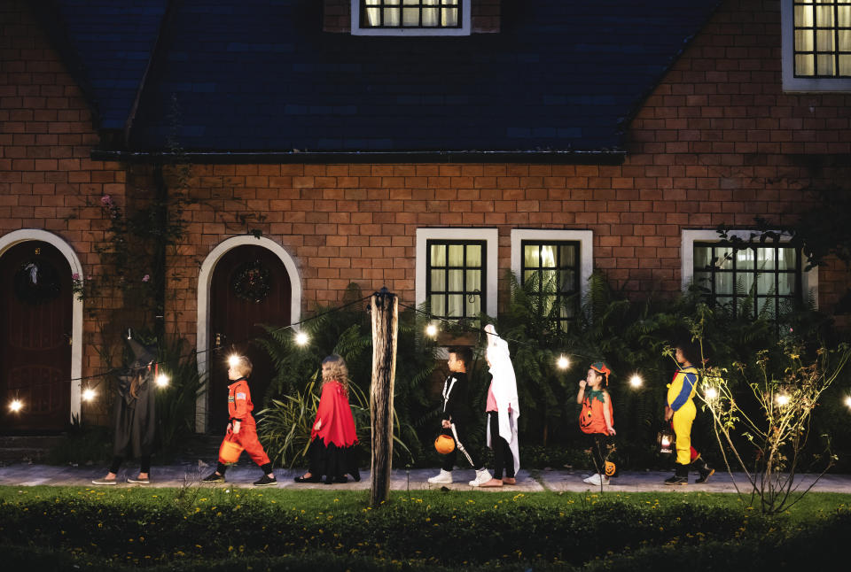 Group of kids with Halloween costumes walking to trick or treating