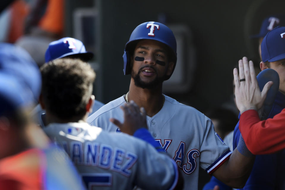 Texas Rangers' Jose Trevino is congratulated after scoring against the Baltimore Orioles in the seventh inning of a baseball game Sunday, Sept. 26, 2021, in Baltimore. (AP Photo/Gail Burton)