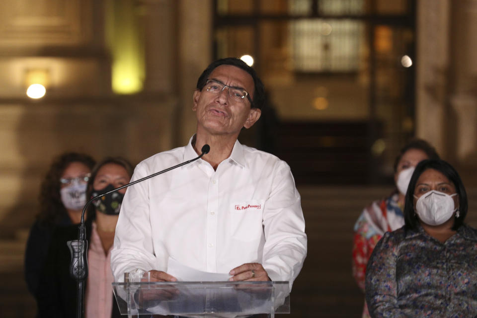 Peru's President Martin Vizcarra speaks in front of the presidential palace after lawmakers voted to remove him from office in Lima, Peru, Monday, Nov. 9, 2020. Peruvian lawmakers voted overwhelmingly to impeach Vizcarra, expressing anger over his handling of the coronavirus pandemic and citing alleged but unproven corruption allegations. (AP Photo/Martin Mejia)