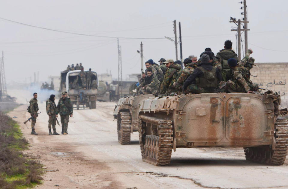 In this photo released Wednesday Feb. 5, 2020 by the Syrian official news agency SANA, shows Syrian government forces entering the village of Tel-Toukan, in Idlib province, northwest Syria. On Thursday, State media and opposition activists said Turkey has sent more reinforcements into northwestern Syria, setting up new positions in an attempt to stop a government offensive on the last rebel stronghold in the war-torn country. (SANA via AP)