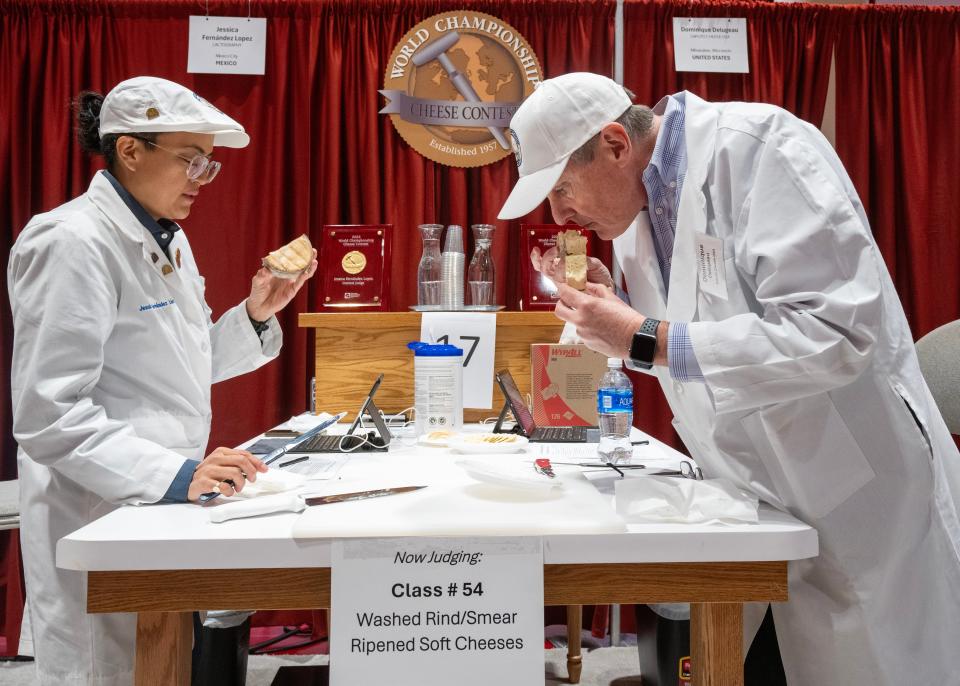 Judges Jessica Fernandez Lopez, left, and Dominique Delugeau examine an entry at the World Championship Cheese Contest in Madison on March 5, 2024. An international panel of judges evaluated 3,302 entries in 115 different cheese classes for the competition.