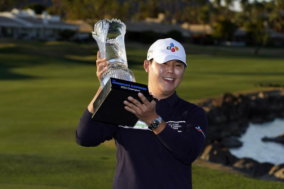 Si Woo Kim holds the winner's trophy at the end of the American Express golf tournament on the Pete Dye Stadium Course at PGA West, Sunday, Jan. 24, 2021, in La Quinta, Calif. (AP Photo/Marcio Jose Sanchez)