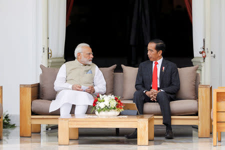 Indian Prime Minister Narendra Modi and Indonesia President Joko Widodo talk during their meeting at the presidential palace in Jakarta, Indonesia May 30, 2018. REUTERS/Darren Whiteside