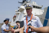 Captain John Driscoll, commanding officer of the U.S. Coast Guard National Security Cutter Bertholf (WMSL 750), background, talks to the media as it arrives for a port call in the first visit by a U.S. cutter in over seven years, Wednesday, May 15, 2019 in Manila, Philippines. Driscoll told reporters that two Chinese Coast Guard ships were spotted off the South China Sea while they were conducting a joint exercise with Philippine Coast Guard. (AP Photo/Bullit Marquez)